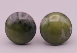 A pair of silver and jade cufflinks. 2 cm diameter.