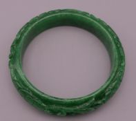 A carved jade bangle. 5.75 cm interior diameter.