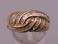 An 18 ct gold cocktail ring. Ring size Q. 6.7 grammes total weight.