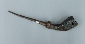 An unusual antique Tibetan copper hammered pipe. 42 cm long.