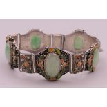 A vintage Chinese jade and enamelled silver bracelet. Approximately 18 cm long.