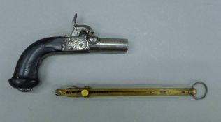A small 'muff' pistol with ebony handle, silver inlay and concealed trigger and a nipple mould.