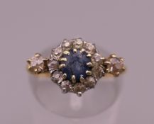 An 18 ct gold diamond and sapphire ring. Ring size L. 3.4 grammes total weight.