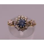 An 18 ct gold diamond and sapphire ring. Ring size L. 3.4 grammes total weight.