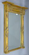 A 19th century gilt pier glass with lion mask motifs. 93.5 cm high x 71.5 cm wide.