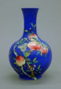 A Chinese blue ground porcelain vase decorated with peaches. 21.5 cm high.