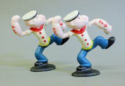 Two cast iron Popeye figures. 13 cm high.