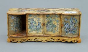 A Chinese soapstone miniature side cabinet with inlaid mother-of-pearl decoration. 24 cm long.