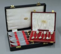 A cased set of six silver teaspoons and a cased set of six antler handled steak knives.