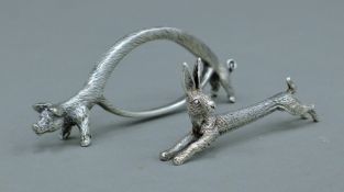 Two silver plated knife rests, one formed as a hare, the other formed as a pig. The latter 11.