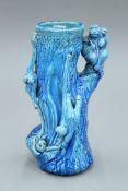 A Chinese blue glazed pottery vase, decorated with monkeys. 25.5 cm high.