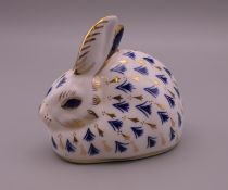 A Royal Crown Derby porcelain rabbit paperweight. 8 cm high.