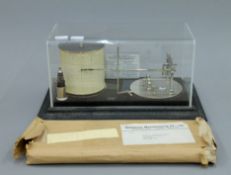 A Short and Mason barograph with paper graphs. 33 cm long.