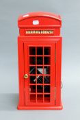 A novelty telephone formed as a telephone box.