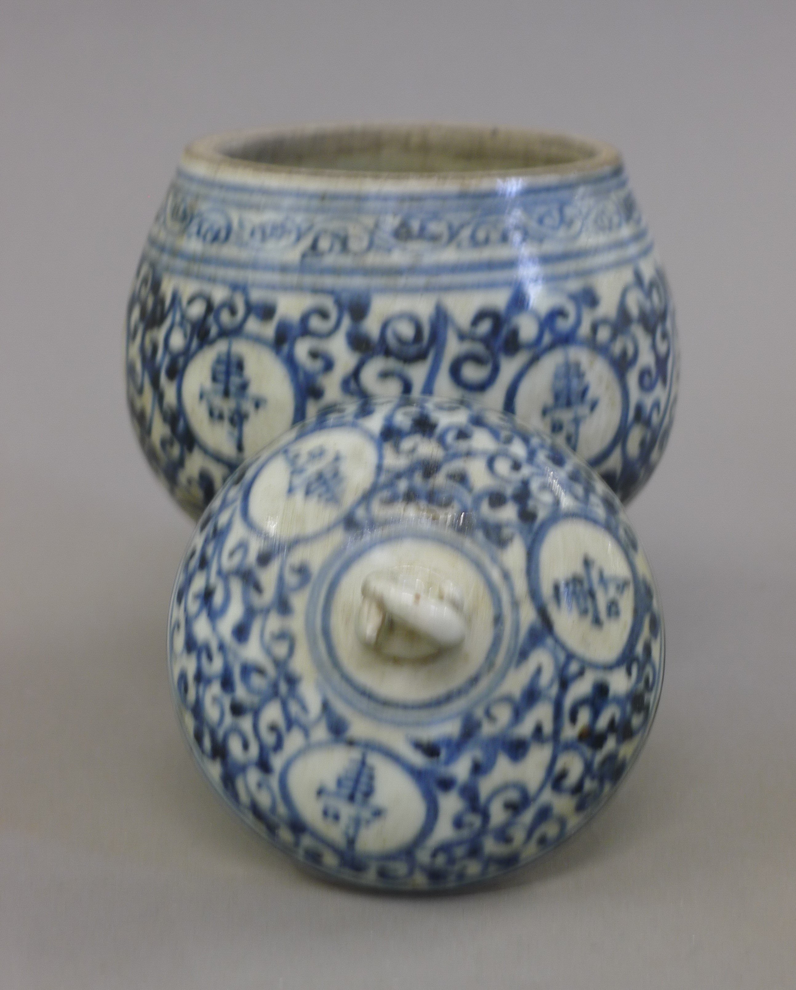 A Chinese blue and white pottery lidded pot with calligraphy. 15 cm high. - Image 2 of 3