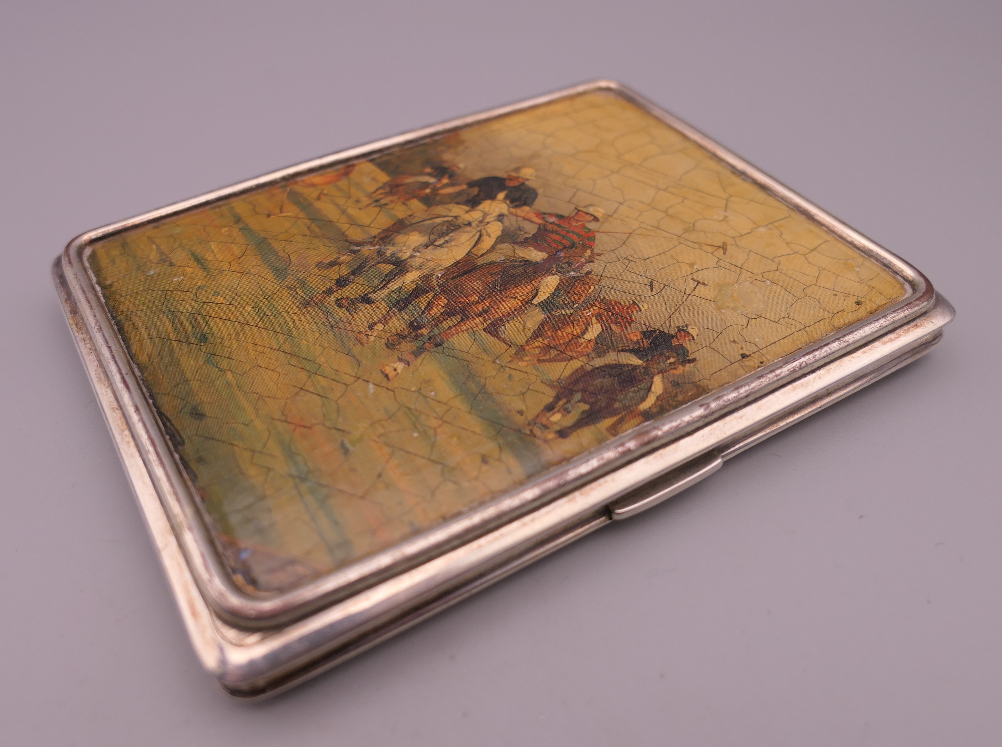 A silver cigarette case decorated with polo scenes. 8.5 cm wide. 219.2 grammes total weight. - Image 3 of 10