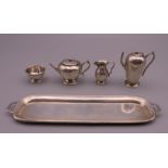 A silver miniature tea set. The tray 13.5 cm long.