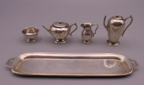 A silver miniature tea set. The tray 13.5 cm long.