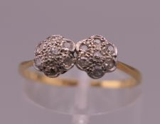 An 18 ct gold and platinum double daisy diamond cluster ring. Ring size M. 1.4 grammes total weight.