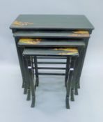 A nest of four chinoiserie lacquered tables. 66.5 cm wide, 71 cm high, 36 cm deep.