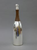 A silver plated and wooden Champagne bottle form cocktail shaker. 37 cm high.