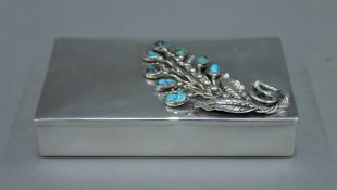 A turquoise set sterling silver lidded box. 14.5 cm wide. 11.4 troy ounces total weight.