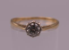 An 18 ct gold and platinum diamond solitaire ring. Ring size O/P. 1.9 grammes total weight.