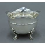 A small silver four footed bowl, hallmarked for Sheffield 1900. 7 cm high. 4.8 troy ounces.