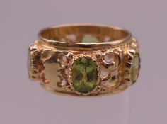 A 14 ct gold peridot ring. Ring size M/N. 8.2 grammes total weight.