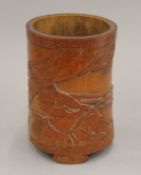 A 19th century Oriental carved bamboo brush pot depicting two Samurai. 16.5 cm high.