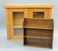 A modern glazed oak cupboard and an oak bookcase. The former 133 cm wide.