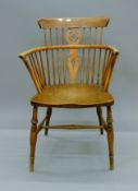 A 19th century elm seated stick back chair. 54 cm wide.