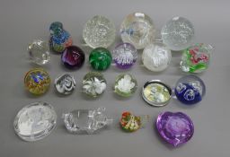 A quantity of glass paperweights and a glass dressing table set.