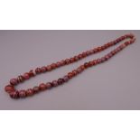 A string of antique graduated banded cornelian beads. 60 cm long.