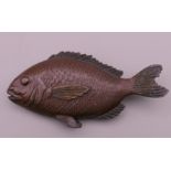 A patinated white metal fish. 10.5 cm long.