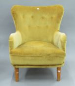 A mid 20th century upholstered armchair. 64 cm wide.