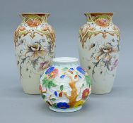 A pair of porcelain vases and a H J Wood vase. The former each 22 cm high.