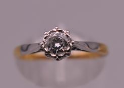 An 18 ct gold diamond solitaire ring. Ring size L. 2 grammes total weight.