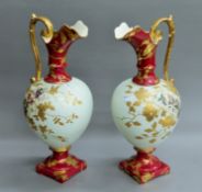 A pair of Victorian decorative porcelain ewers. 41 cm high.