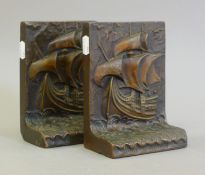 A pair of bookends decorated with ships. 17.5 cm high.