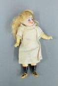 A miniature vintage bisque headed doll. 16 cm high.