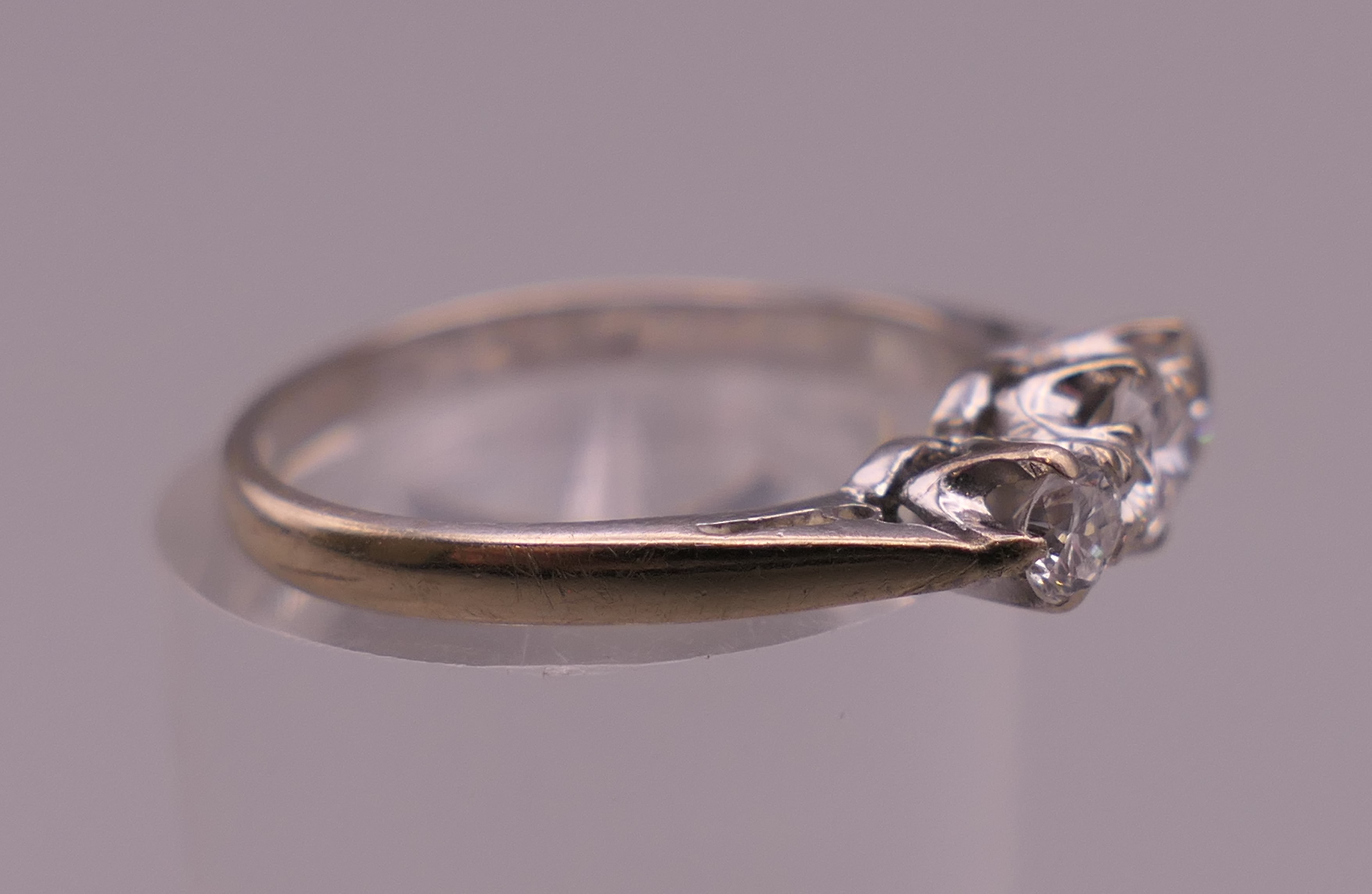 An 18 ct white gold three stone diamond ring. Ring size K/L. 2.5 grammes total weight. - Image 2 of 6