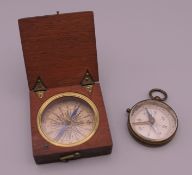 A Victorian compass in small wooden travelling case and a small Victorian gilded brass compass.