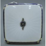 An enamel decorated silver compact. 6.5 cm square.