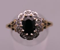 A 9 ct gold diamond and sapphire ring. Ring size S/T. 2.5 grammes total weight.