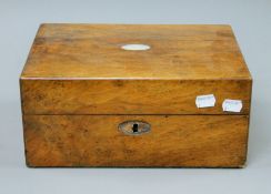 A Victorian walnut work box. 30 cm wide.