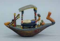 An Egyptian model of a funerary boat. 19 cm long.