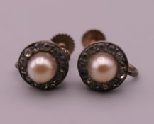 A pair of 9 ct gold mounted pearl screw fix earrings. 8 mm diameter.