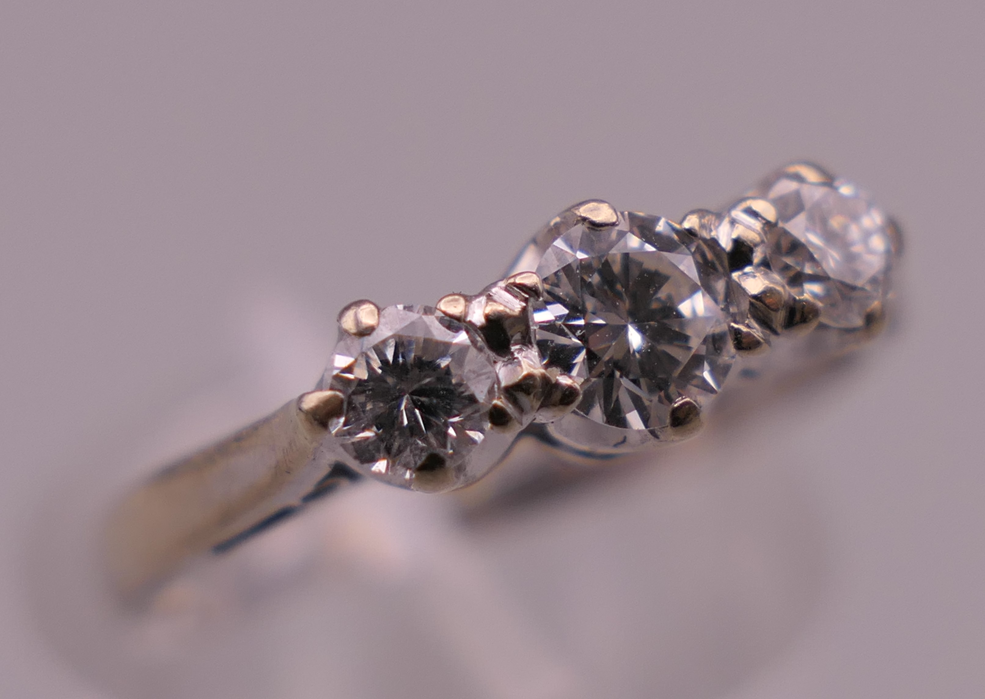 An 18 ct white gold three stone diamond ring. Ring size K/L. 2.5 grammes total weight. - Image 5 of 6