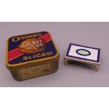 An Ogden's walnut plug tin and an enamel decorated silver match box cover. The latter 4.5 cm wide.